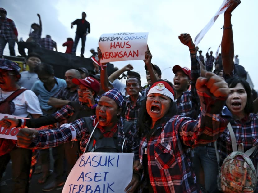 Supporters of Jakarta Governor Basuki "Ahok" Tjahaja Purnama shout slogans during a rally outside Cipinang Prison where he is being held after a court sentenced him to two years in prison, in Jakarta, Indonesia, Tuesday, May 9, 2017. Source: AP
