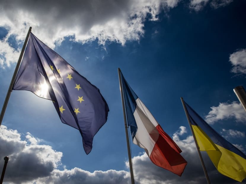 A photograph taken on Sept 21, 2022 at the entrance of the museum Louvre-Lens in Lens, northern France, shows the flag of the European Union, the French flag and the Ukrainian flag. A photograph taken on Sept 21, 2022 at the entrance of the museum Louvre-Lens in Lens, northern France, shows the flag of the European Union, the French flag and the Ukrainian flag.