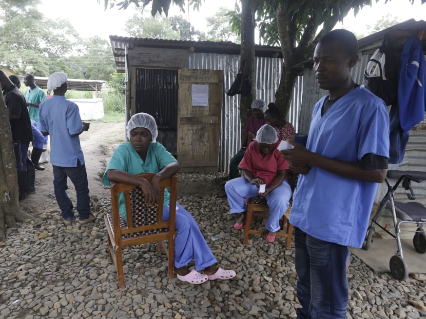 In this Aug 10, 2015 photo, Maxon Kobba, right, a nurse who works at the government hospital in Kenema, eastern Sierra Leone stands next to colleagues at the facility. Photo: AP