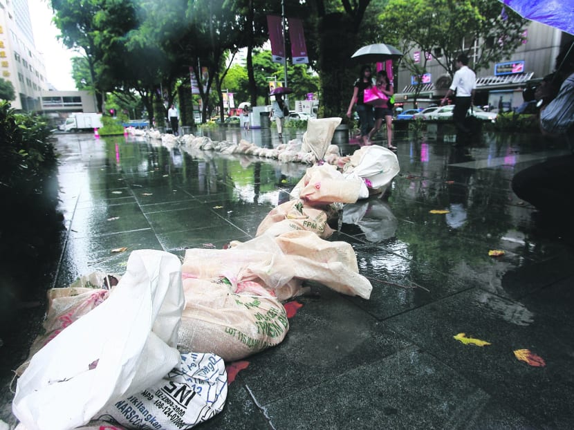 Sandbags placed outside Liat Towers to prevent flooding in 2010. The risk of floods will increase with global warming. TODAY file photo