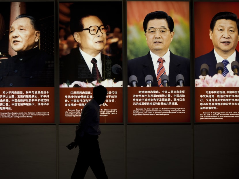 A man walks past the images of China's past and present leaders from left, Deng Xiaoping, Jiang Zemin, Hu Jintao and Xi Jinping on display at a museum in Beijing. One wore a cowboy hat. Another visited Disneyland and Hollywood. Photo: AP