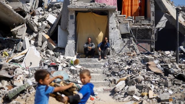 Battles rage across Gaza, Israel releases images of armed men at UN site