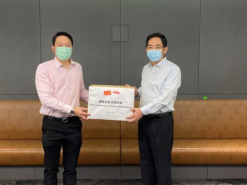 Senior Minister of State for Health Lam Pin Min received the masks from Chinese Ambassador to Singapore Hong Xiaoyong on May 5, 2020.
