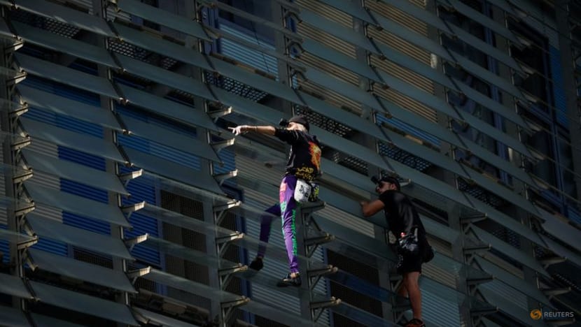 French Spiderman' climbs first skyscraper with son in Barcelona - CNA