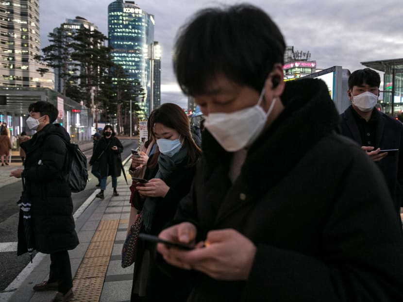 Pedestrians wearing masks in downtown Seoul on Feb. 25, 2020. The authors say that climate change and epidemics are both problems of the global commons. Effective solutions require cooperation and coordination between governments.