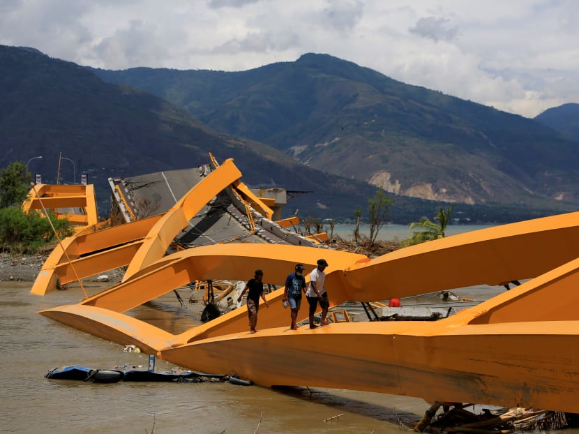 Photo of the day: People walking on a broken bridge on Sunday (Oct 7) after it was hit by an earthquake and tsunami last week in Palu, of Indonesia's Sulawesi Island.