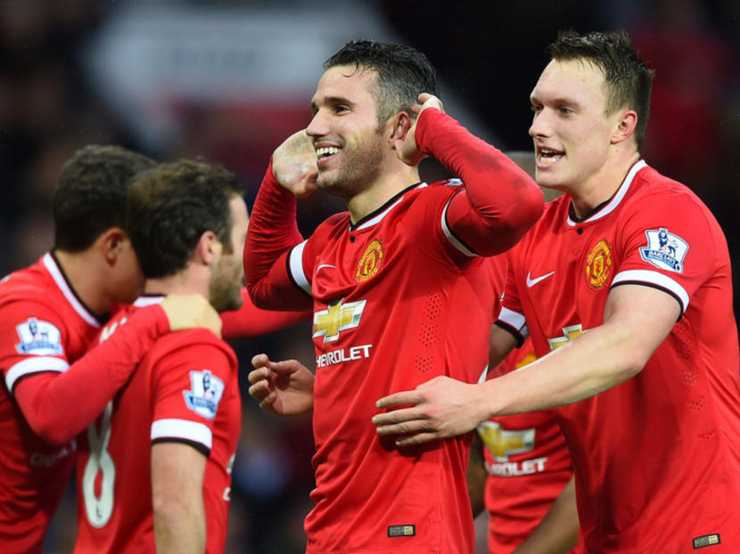 Robin van Persie leads the celebrations as United enjoy a morale-boosting win over their great rivals. Photo: Getty Images