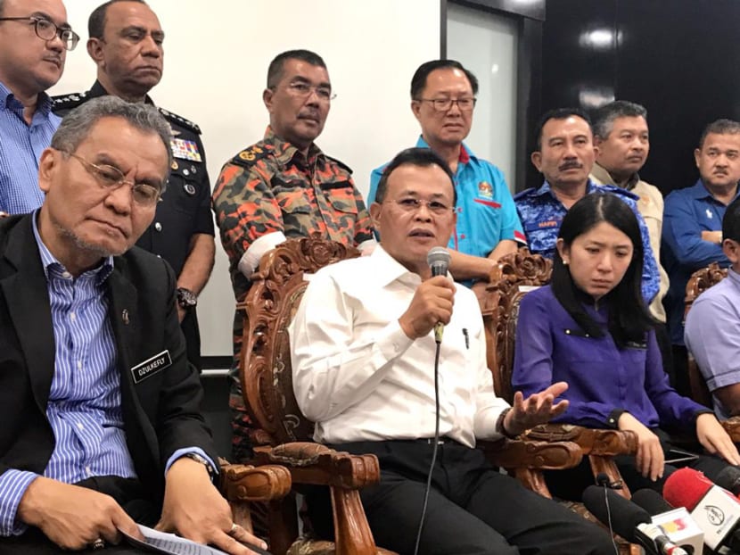 Johor Chief Minister Osman Sapian (seated, centre) said there was no need to evacuate or move residents living along the river in light of the toxic fumes in Pasir Gudang.