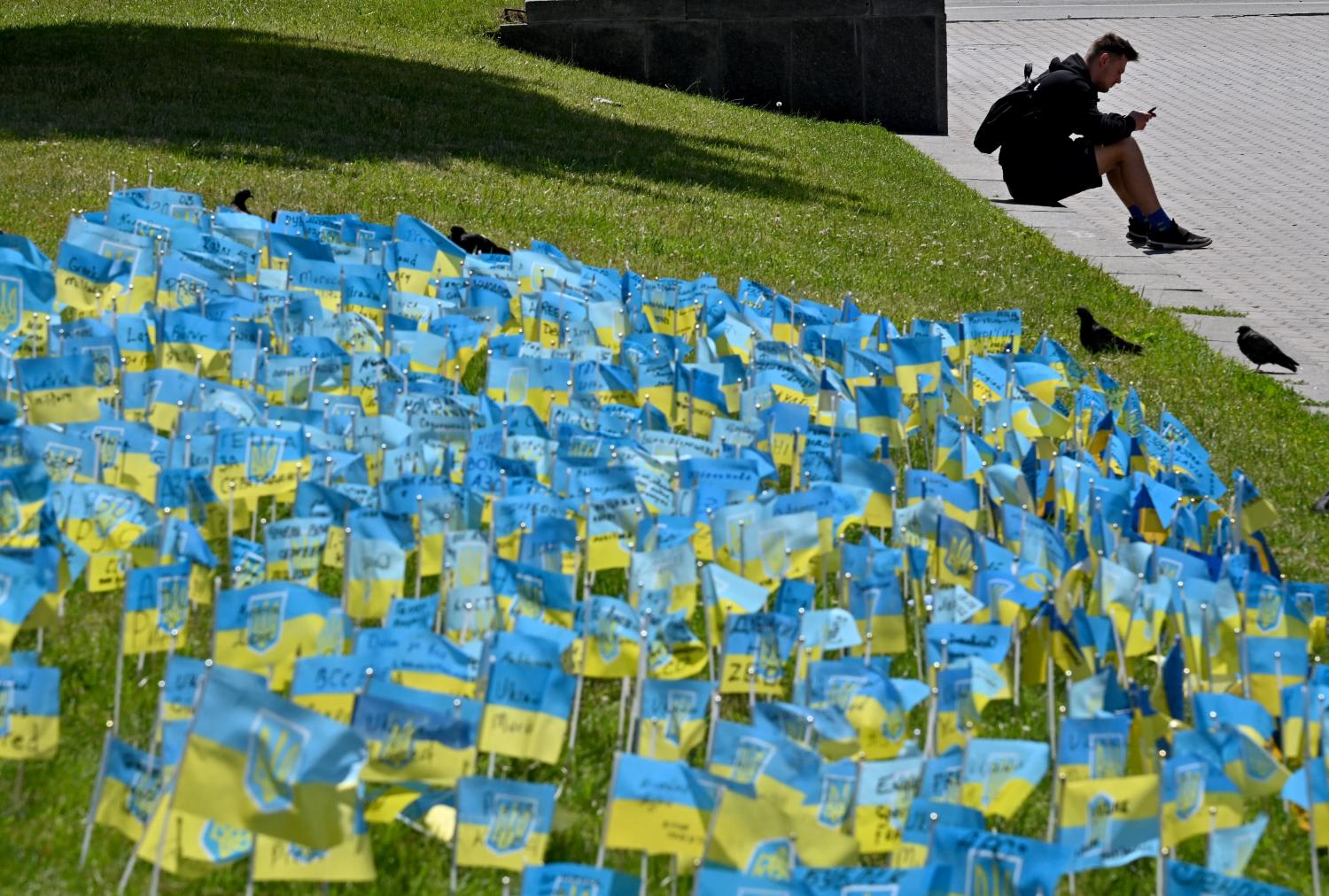 A grass plot decorated with small Ukrainian flags signed with the names of the Ukrainian servicemen killed in the war with Russia, in the center of Ukrainian capital of Kyiv on June 22, 2022.
