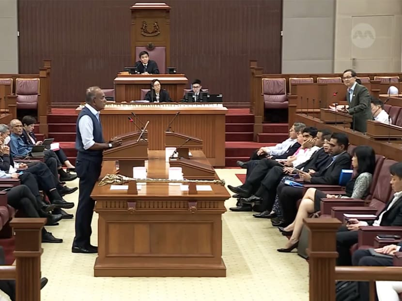 Law and Home Affairs Minister K Shanmugam addresses Parliament on March 22, 2023. NCMP Leong Mun Wai can be seen standing (right).
