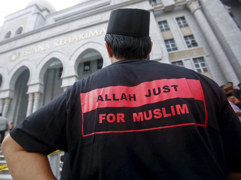 A Muslim man stands outside the court in Putrajaya outside Kuala Lumpur. Photo: Reuters