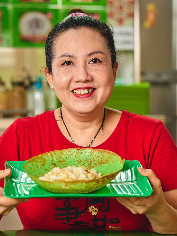 Madam Nguyen Thi Kieu Hanh, owner of Mr Appam hawker stall, with the food items on sale.