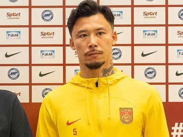 China's football captain Zhang Linpeng posing for photographers at a press conference on March 20, 2024 ahead of the Fifa World Cup qualifier against Singapore.