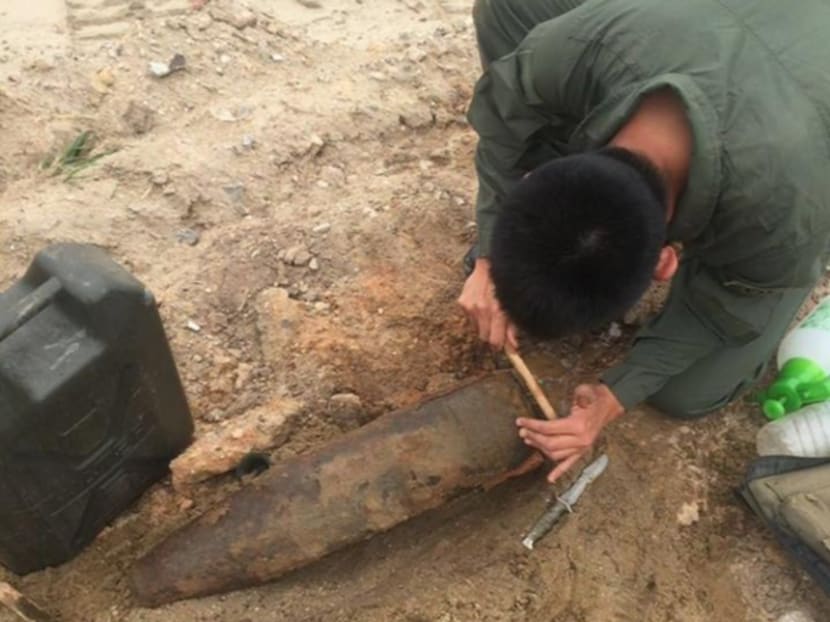 The EOD team conducting an assessment to identify the war relic. Photo: Singapore Army/Facebook