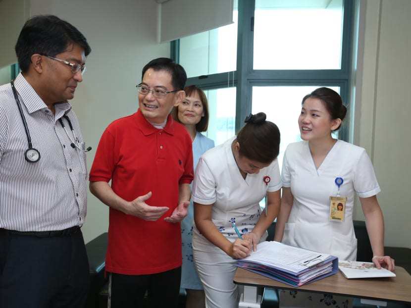 Mr Heng being discharged from Tan Tock Seng Hospital accompanied by doctor and nurses.