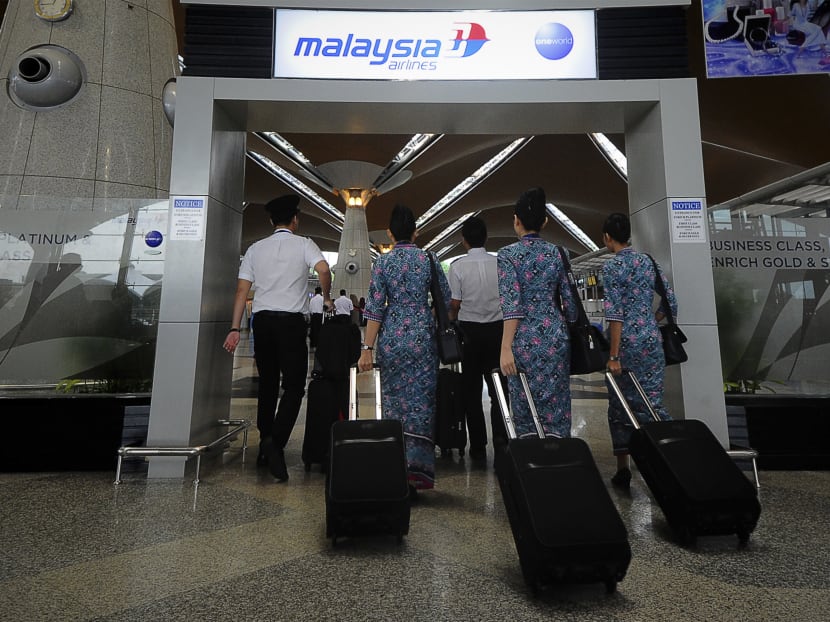 In this April 10, 2014 file photo, a Malaysia Airlines crew walks into a check in area at Kuala Lumpur International Airport in Sepang, Malaysia.  Photo: AP