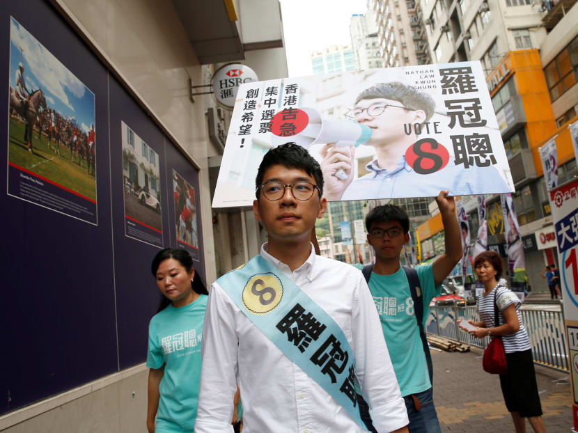 File photo of Nathan Law (C), candidate from Demosisto, campaigning with student activist Joshua Wong on election day for the Legislative Council in Hong Kong, China Sep  4, 2016. Photo: Reuters