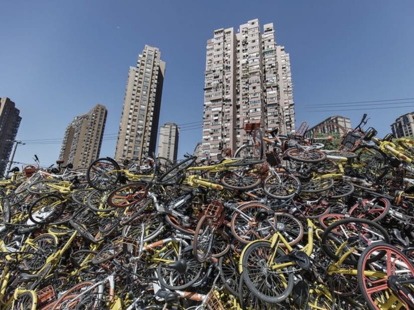 Ride-sharing bicycles sit in a pile in Shanghai.Photo: Bloomberg