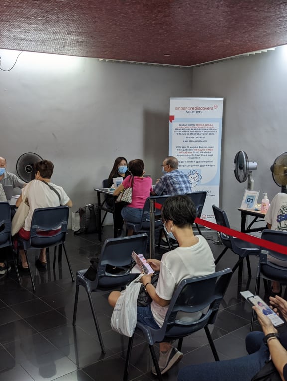 Nearly 30 people were seen waiting to redeem their SingapoRediscovers Vouchers at the Marine Parade Community Club at about 1.30pm on Dec 31, 2021. 