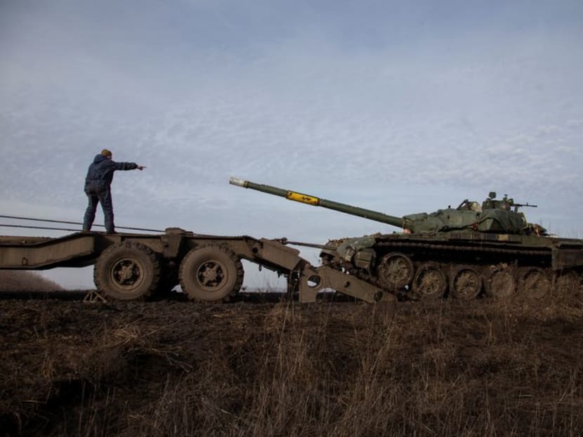 FILE PHOTO: A Ukrainian serviceman gestures during pulling a broken tank to a truck near the frontline town of Bakhmut, amid Russia's attack on Ukraine, in Donetsk region, Ukraine January 20, 2023. REUTERS/Oleksandr Ratushniak FILE PHOTO: A Ukrainian serviceman gestures during pulling a broken tank to a truck near the frontline town of Bakhmut, amid Russia's attack on Ukraine, in Donetsk region, Ukraine January 20, 2023. REUTERS/Oleksandr Ratushniak