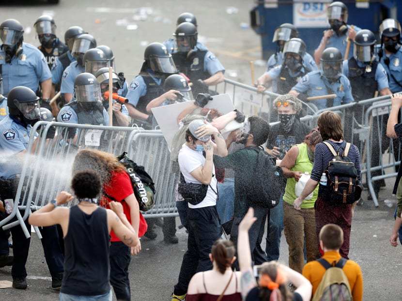 Police spray mace at protestors to break up a gathering near the Minneapolis Police third precinct after a white police officer was caught on a bystander's video pressing his knee into the neck of African-American man George Floyd, who later died at a hospital, in Minneapolis, Minnesota, US, May 27, 2020.