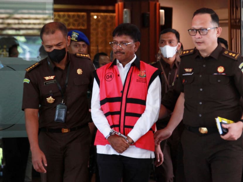 Indonesian Communications and Informatics Minister Johnny G Plate (in pink vest) walks at the Attorney General's Office following accusations of corruption in Jakarta, Indonesia on May 17, 2023.