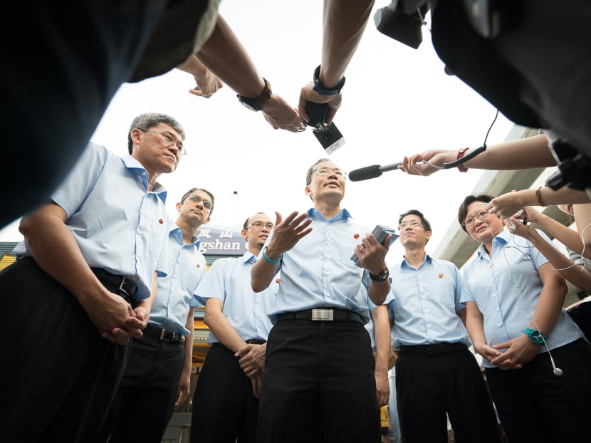 Fengshan SMC candidate Dennis Tan is surrounded by Workers' Party members as he speaks to the media. Photo: Ray Chua
