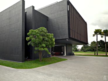 A structure built to look like an impenetrable bunker is actually home to a multigenerational Thai family