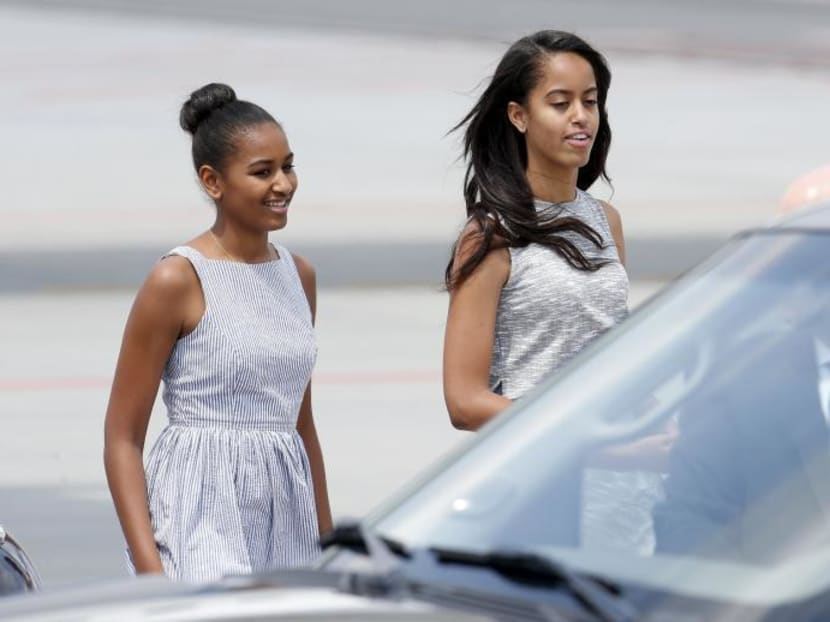 President Barack Obama's daughters Sasha (left) and Malia walk as they arrive at Malpensa airport in Milan, Italy, on June 17, 2015. Photo: Reuters