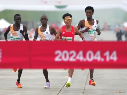 Chinese runner He Jie, Ethiopian Dejene Hailu Bikila and Kenyans Robert Keter and Willy Mnangat take part in a half-marathon in Beijing, China April 14, 2024.