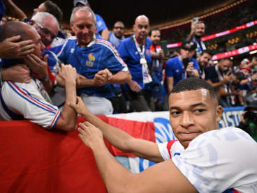 France's forward Kylian Mbappe apologises to fan after hitting him in the face with a ball ahead of the Qatar 2022 World Cup semi-final football match between France and Morocco at the Al-Bayt Stadium in Al Khor, north of Doha on Dec 14, 2022.
