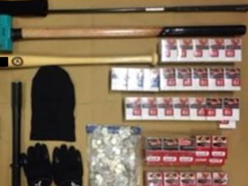 Cash, cartons of cigarettes, gloves, a balaclava and an assortment of weapons were recovered and seized as case exhibits. Photo: SPF