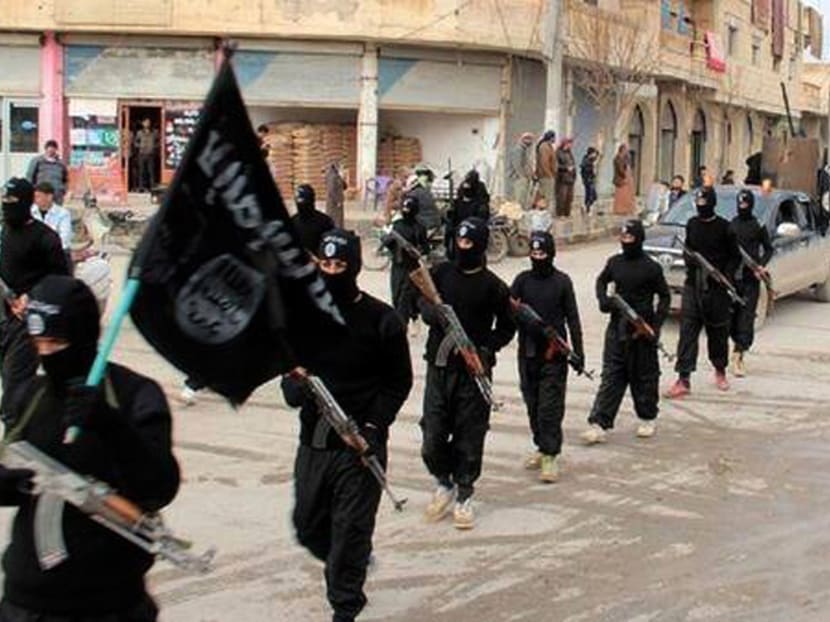 This undated file image posted on a militant website on Jan 14, 2014, which has been verified and is consistent with other AP reporting, shows fighters from the Islamic State group, marching in Raqqa, Syria. Photo: Militant Website via AP