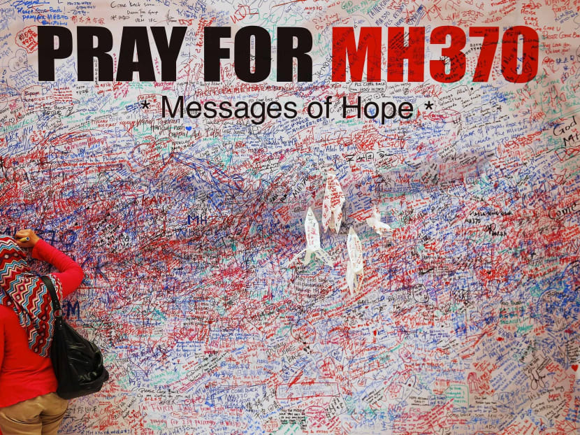 A woman leaves a message of support and hope for the passengers of the missing Malaysia Airlines MH370 in central Kuala Lumpur in this March 16, 2014 file photo. Photo: Reuters