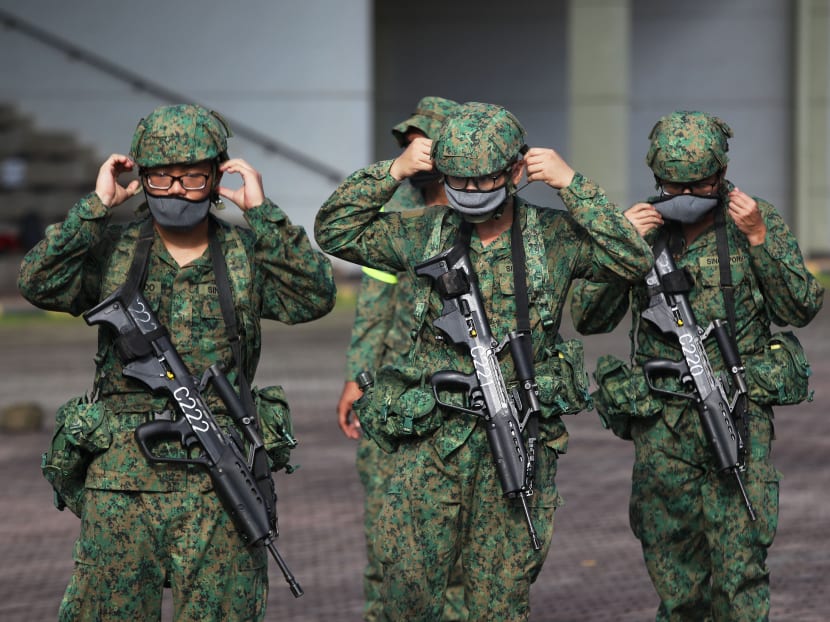 Recruits putting on their masks during a training session at the Basic Military Training Centre in Pulau Tekong.