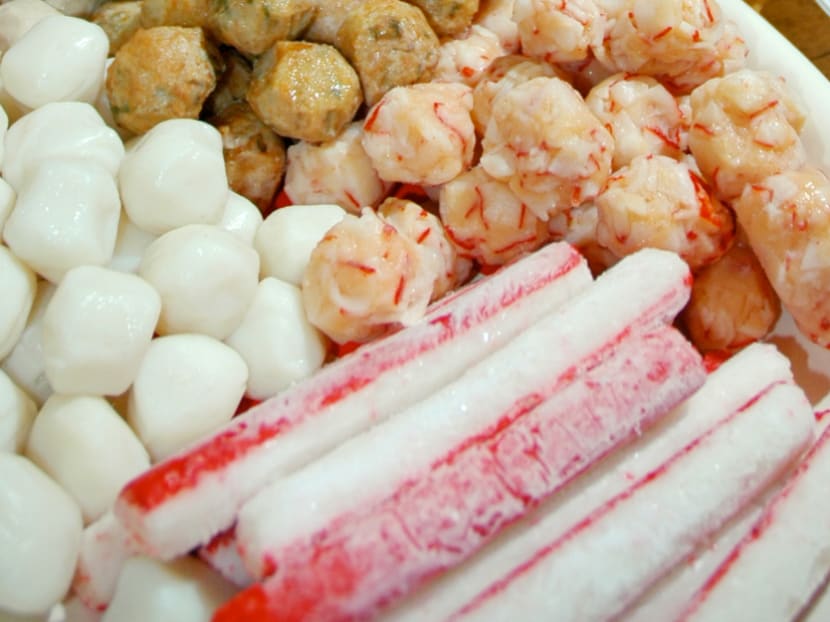 A close-up view of processed seafood such as prawn balls and crab sticks.