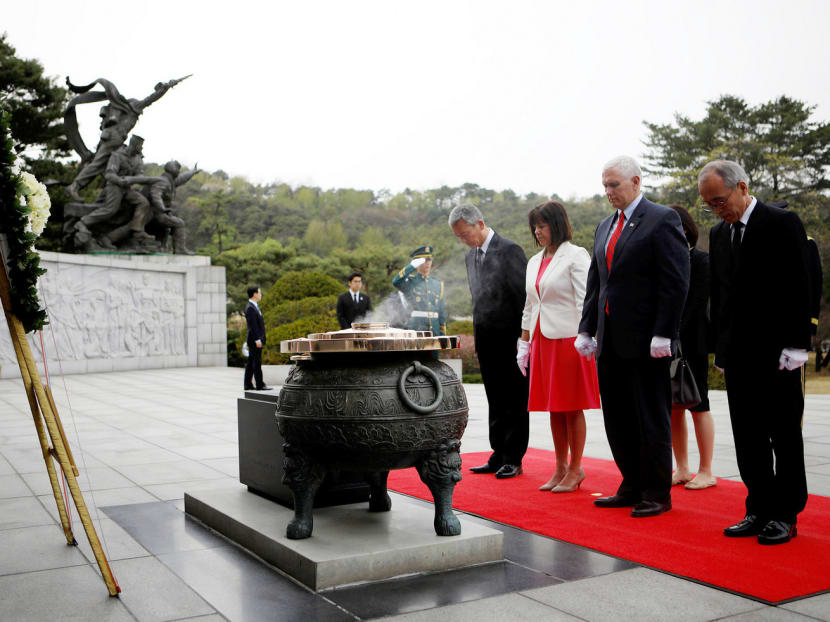 US Vice-President Mike Pence (second from right) visiting the National Cemetery in Seoul yesterday. Mr Pence is in Seoul as part of a 10-day trip to Asia and said the US’ commitment to South Korea remained firm. Photo: Reuters
