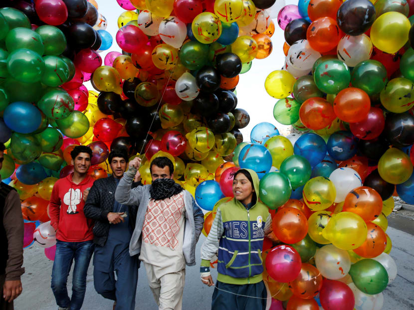 Photo of the day: Men hold balloons for sale during Afghan spring and new year celebrations in Kabul, Afghanistan on Wednesday, March 21, 2018. Photo: Reuters