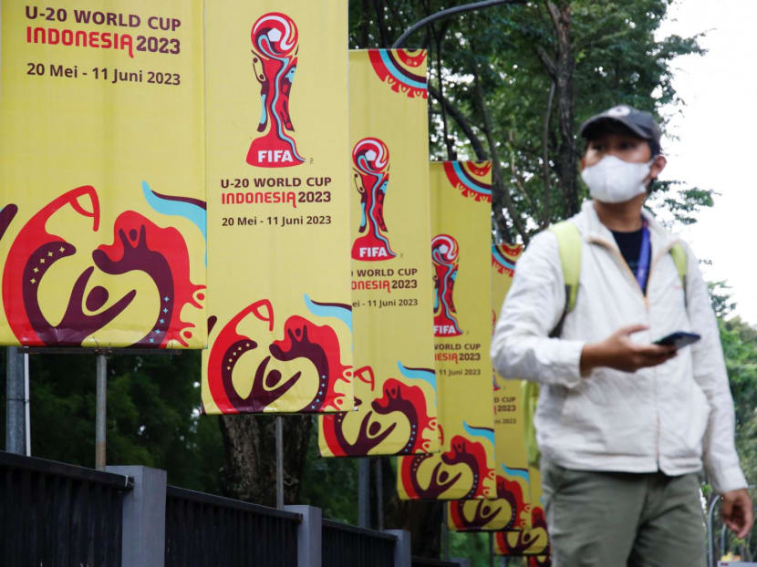 A man walks past banners for the Fifa Under-20 World Cup outside Indonesia's football federation office on March 30, 2023.