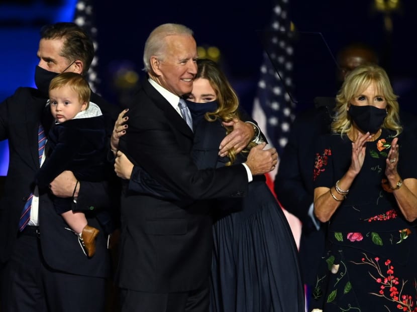 US president-elect Joe Biden hugging one of his granddaughters as he stands with wife Jill Biden (far right), and grandson and son Hunter Biden (left) in Wilmington, Delaware, on Nov 7, 2020, after he was declared the winner of the presidential election.