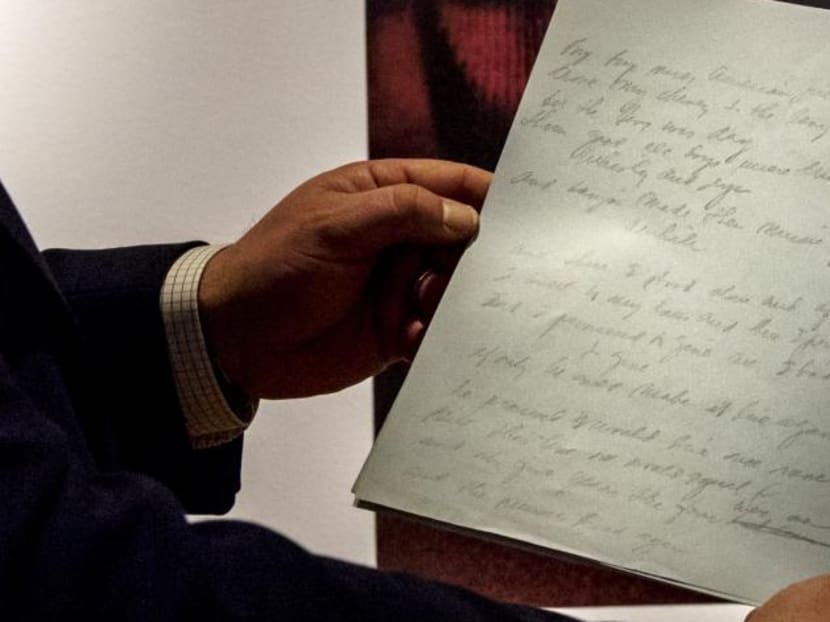 Christie's curator Tom Lecky holds the original manuscript for singer Don McLean's American Pie at Christie's auction house in New York on April 2, 2015. Photo: Reuters