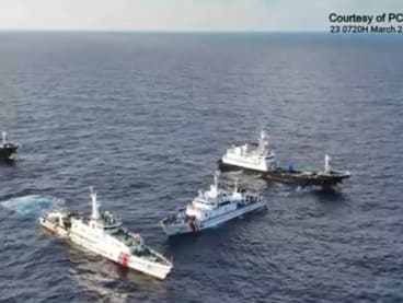 A China Coast Guard ship (second from left) and vessels identified by the Philippine Coast Guard as “Chinese Maritime Militia” (left and right) surrounding the Philippine Coast Guard ship BRP Cabra (second from right) during its supply mission near Second Thomas Shoal in waters of the disputed South China Sea on March 23, 2024. 