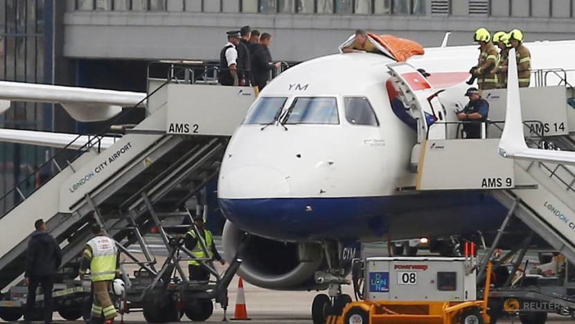 Climate protester lies on plane in disruption at London City airport Climate protester lies on plane in disruption at London City airport
