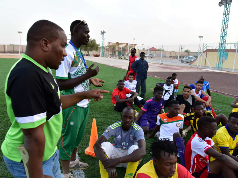 Bachir Ama, left, president of the Nassara Agadez football club, has hired four Nigerians and four Ivorians stranded while waiting to reach north Africa or Europe. Photo: AFP