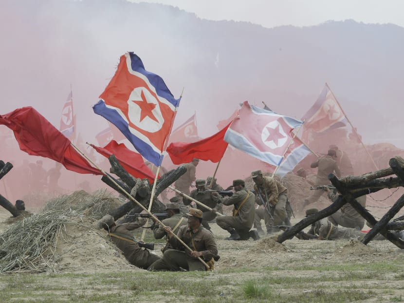 South Korean soldiers dressed like North Korean soldiers waving North Korean flags during a re-enactment of the Naktong River Battle, as part of commemoration events for the 66th anniversary of the Korean War. Rejecting the possibility of holding peace talks with the North, South Korean President Park Geun-hye said money had been given to the North in the past for the sake of dialogue, but it was used to develop nuclear weapons. Photo: AP