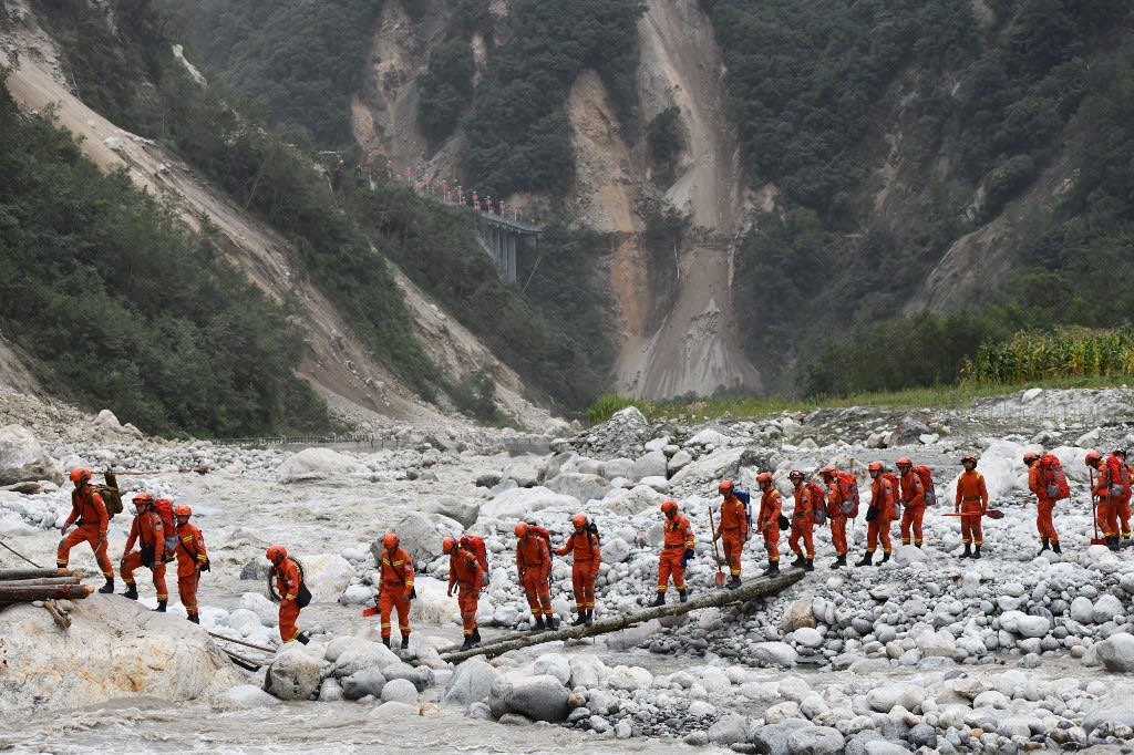 This photo taken on Sept 6, 2022 shows rescuers crossing a makeshift bridge as they head to an earthquake-affected area following a 6.6-magnitude earthquake that struck Sept 5, in Luding county, Ganzi Prefecture, in China's southwestern Sichuan province.
