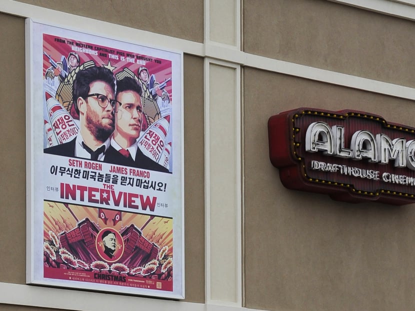 A large poster advertising the movie The Interview hangs on the back wall of the Alamo Drafthouse Cinema Dec 23, 2014, in Houston. Photo: AP