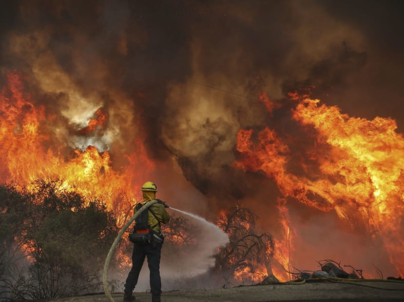 San Miguel County Firefighters battle a brush fire along Japatul Road during the Valley Fire in Jamul, California on Sep 6, 2020. The Valley Fire in the Japatul Valley burned 4,000 acres overnight with no containment and 10 structures destroyed, Cal Fire San Diego said.