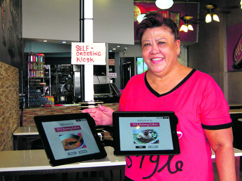 363 Katong Laksa Co-Owner Tan Ah Hiok, 60. Her Holland Village coffee shop has deployed a variety of e-solutions, from an electronic self-service kiosk (picture) to computerised ovens and fridges. PHOTO: TABSQUARE