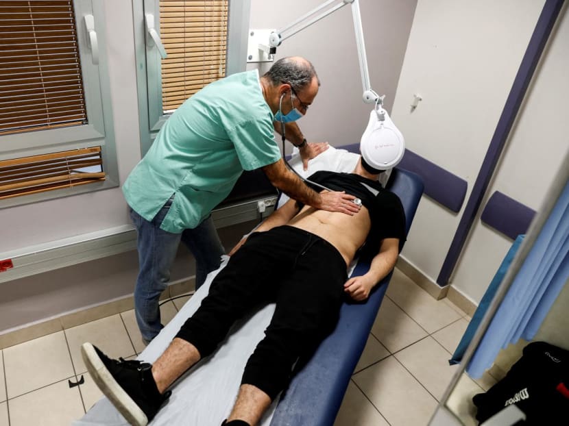 A patient suffering from long Covid is examined in the post-Covid clinic of Ichilov Hospital in Tel Aviv, Israel, Feb 21, 2022. A patient suffering from long Covid is examined in the post-Covid clinic of Ichilov Hospital in Tel Aviv, Israel, Feb 21, 2022.